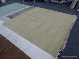 SQUARE AREA RUG; TAN MEDIUM PILE MACHINE MADE AREA RUG. DOES HAVE SOME SPOTTING. MEASURES