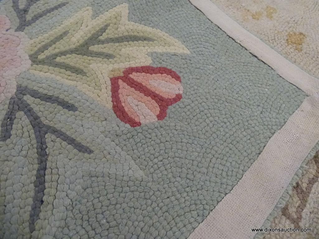 HAND KNOTTED AREA RUG; FLAT WEAVE SAGE GREEN AND TAN RUG WITH PINK, RED, AND BLUE FLOWERS. MEASURES
