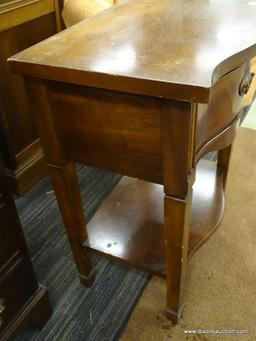 DIXIE END TABLE; WOODEN END TABLE WITH A SERPENTINE FRONT, A TOP DRAWER, AND A LOWER SHELF. TABLE