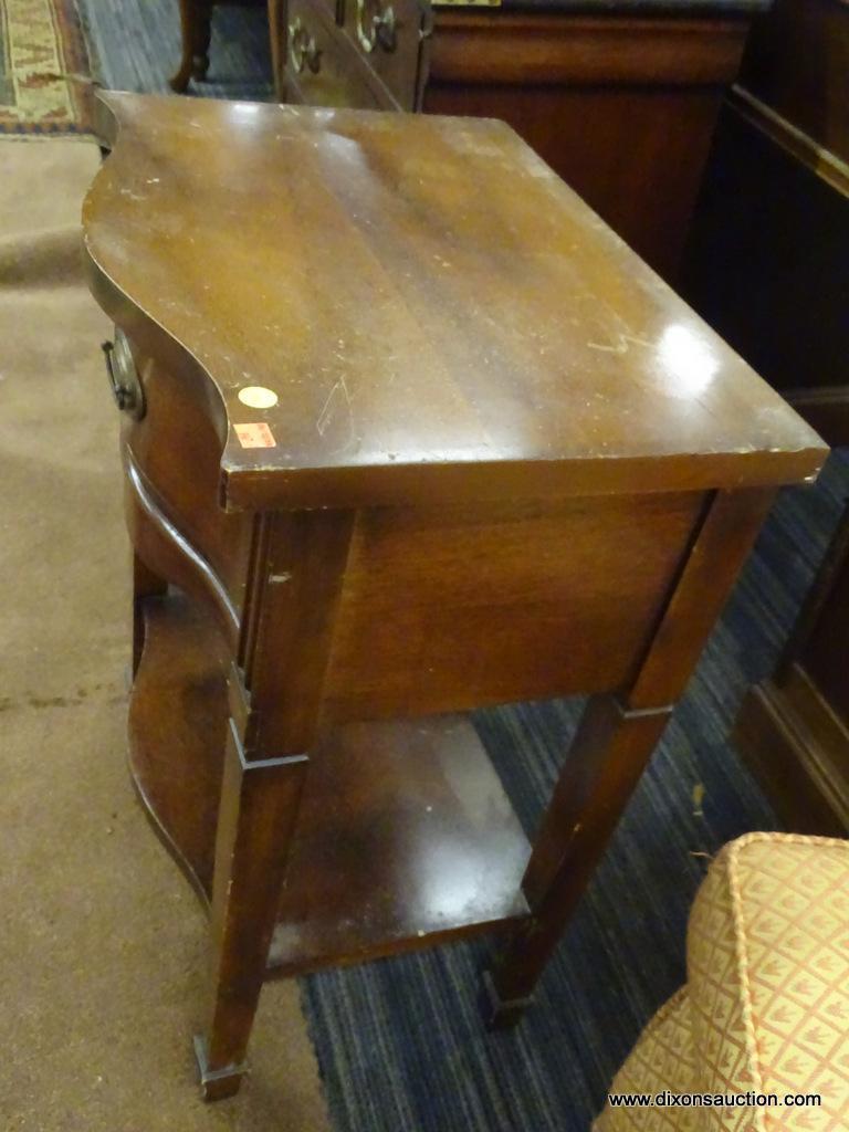DIXIE END TABLE; WOODEN END TABLE WITH A SERPENTINE FRONT, A TOP DRAWER, AND A LOWER SHELF. TABLE