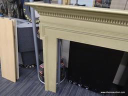 VINTAGE FIREPLACE MANTELS; CREAM/PALE YELLOW COLORED WOODEN MANTEL WITH DENTAL MOLDING AROUND THE