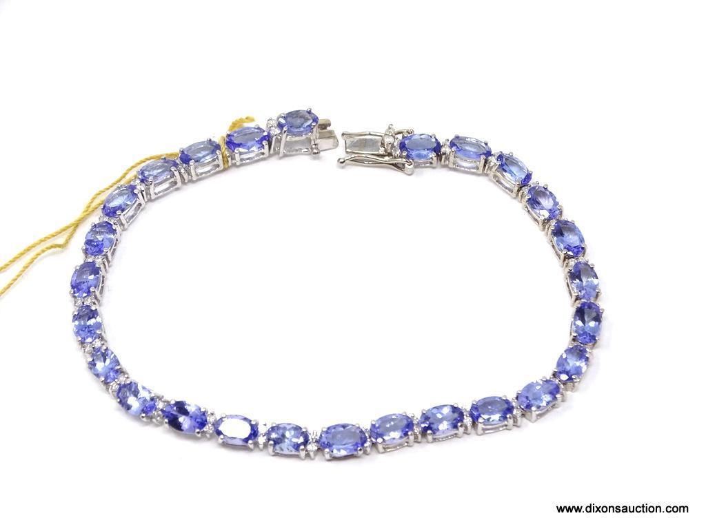 TANZANITE AND DIAMOND 7 INCH BRACELET; 14KT WHITE GOLD SETTING WITH 26 OVAL MIXED CUT NATURAL