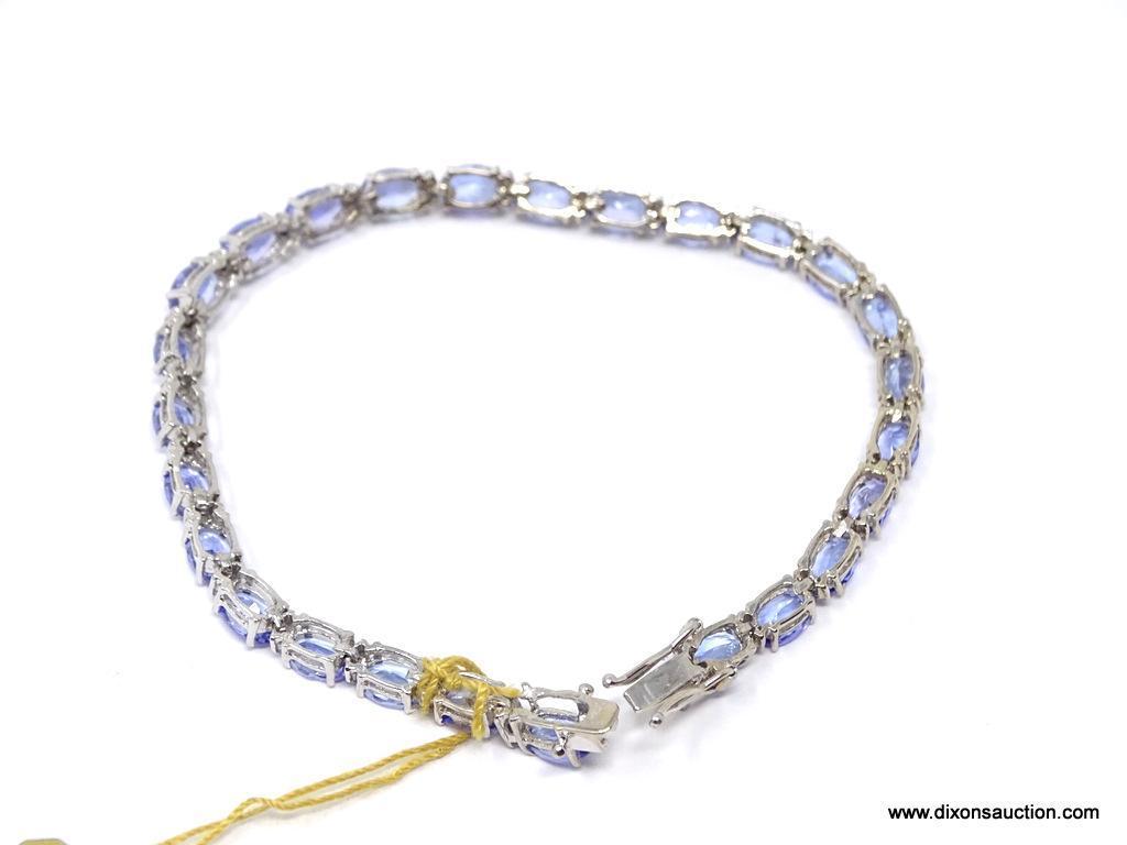 TANZANITE AND DIAMOND 7 INCH BRACELET; 14KT WHITE GOLD SETTING WITH 26 OVAL MIXED CUT NATURAL