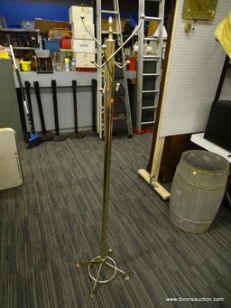 METAL COAT HANGER; COAT HANGER WITH A GOLD TONE FINISH. HAS 6 HOOKS FOR HANGING AND SITS ON 4 LEGS