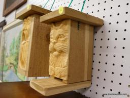 (R1) BIRD HOUSE; HANDMADE BIRD HOUSE WITH A CARVED CAT ON THE FRONT WITH SLOT ENTRY. MEASURES 5.5 IN