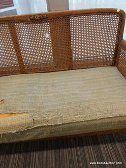 (DOOR) WICKER LOVESEAT; WOODEN LOVESEAT WITH A WICKER LACED BACK AND SIDES AND ROLL ARMS. HAS A
