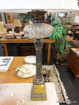 (R1) TABLE LAMP; VINTAGE OIL LAMP CONVERTED TO ELECTRIC WITH A COLUMN SHAPED STEM SITTING ON A GOLD