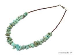 TURQUOISE NECKLACE; SMALL STONE TURQUOISE NECKLACE WITH SMALL BROWN BEADS. HAS A HOOK CLOSURE. 15 IN