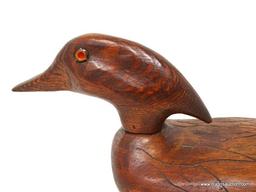 SOLID BODY WOOD DUCK DECOY. SIGNED JIM MANNING. NATURAL FINISH. FEATHER CARVED RELIEF. MOVABLE HEAD.