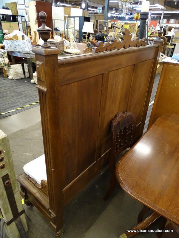 (R2) WOODEN CHURCH PEW; HAS REEDED DETAILING, ORNATE SCROLLING AT THE TOP, AND A WHITE BENCH