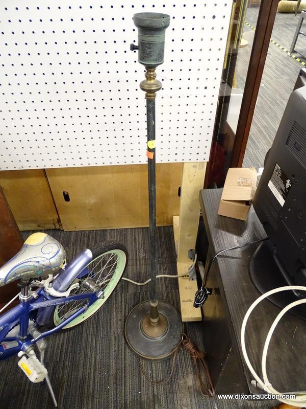 FLOOR LAMP. TURNED METAL FLOOR LAMP AND HAS A TURN-KNOB SWITCH. MEASURES 4 FT TALL, NEEDS LAMPSHADE.