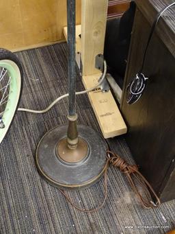 FLOOR LAMP. TURNED METAL FLOOR LAMP AND HAS A TURN-KNOB SWITCH. MEASURES 4 FT TALL, NEEDS LAMPSHADE.