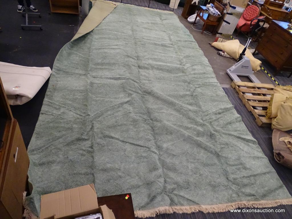 KARASTAN MACHINE WOVEN RUG; HAS A SOLID STERLING JADE COLOR WITH THICK WOOL. HAS FRINGES ON 2 ENDS.