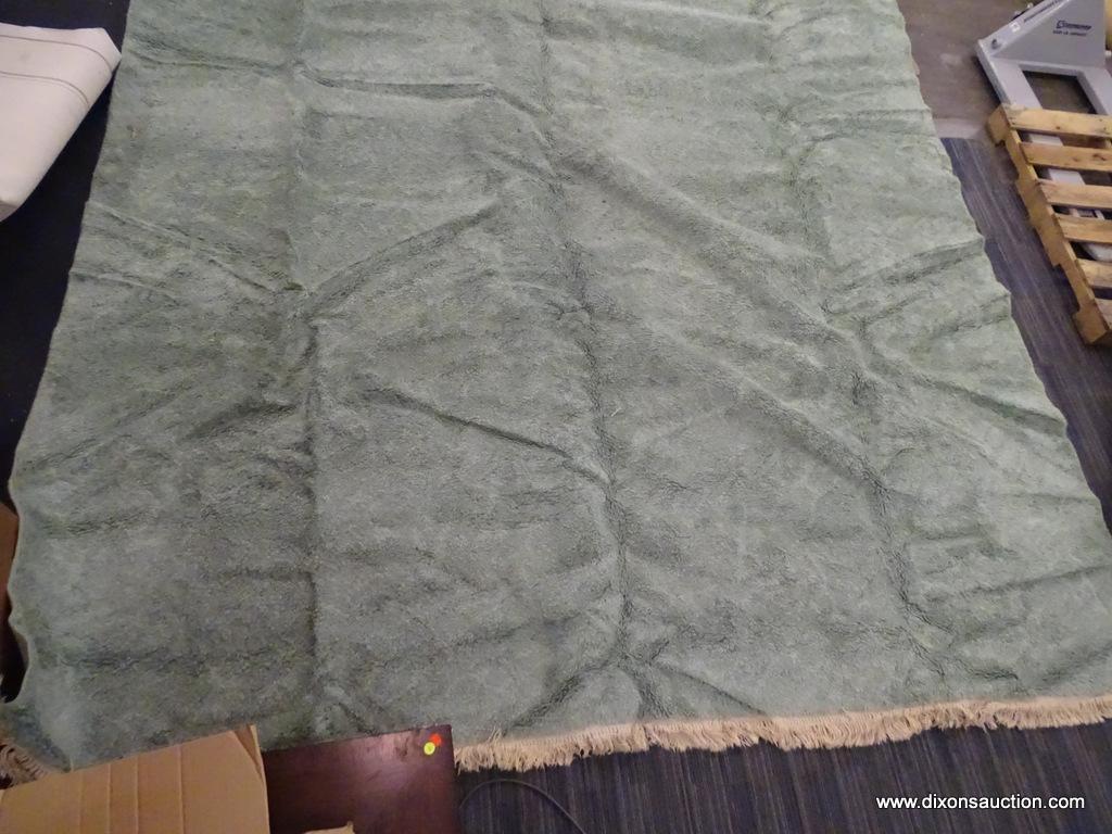 KARASTAN MACHINE WOVEN RUG; HAS A SOLID STERLING JADE COLOR WITH THICK WOOL. HAS FRINGES ON 2 ENDS.