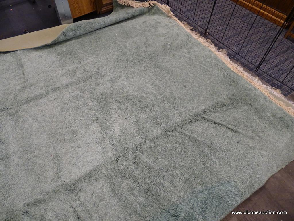KARASTAN MACHINE WOVEN RUG; HAS A SOLID STERLING JADE COLOR WITH THICK WOOL. HAS FRINGES ON 2 ENDS.
