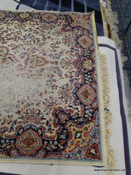 FLORAL AREA RUG; HAS A CREAM, ORANGE, NAVY, AND LIGHT BLUE COLORED GEOMETRIC FLORAL PATTERN. HAS