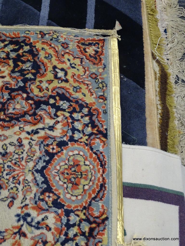 FLORAL AREA RUG; HAS A CREAM, ORANGE, NAVY, AND LIGHT BLUE COLORED GEOMETRIC FLORAL PATTERN. HAS