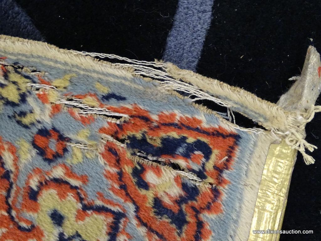 FLORAL AREA RUG; HAS A CREAM, ORANGE, NAVY, AND LIGHT BLUE COLORED GEOMETRIC FLORAL PATTERN. HAS