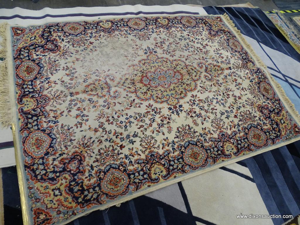 FLORAL AREA RUG; HAS A CREAM, ORANGE, NAVY, AND LIGHT BLUE COLORED GEOMETRIC FLORAL PATTERN. HAS