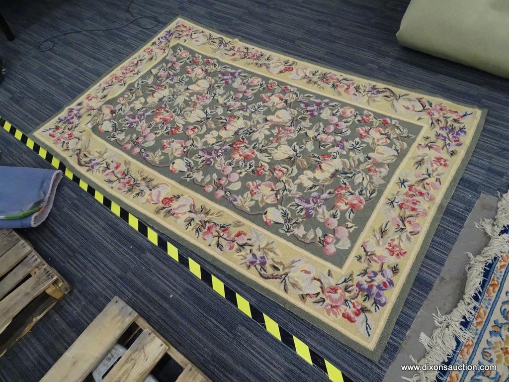 FLORAL AREA RUG; HAND WOVEN AREA RUG WITH A GREEN AND YELLOW COLOR BASE AND A PURPLE AND PINK FLOWER