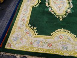 ORIENTAL AREA RUG; GREEN, YELLOW, AND CREAM ORIENTAL AREA RUG WITH YELLOW, BLUE AND RED FLOWERS. HAS