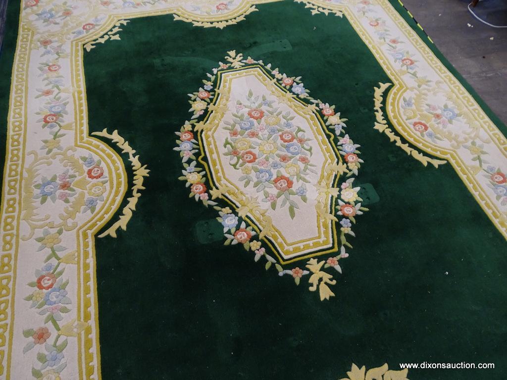 ORIENTAL AREA RUG; GREEN, YELLOW, AND CREAM ORIENTAL AREA RUG WITH YELLOW, BLUE AND RED FLOWERS. HAS