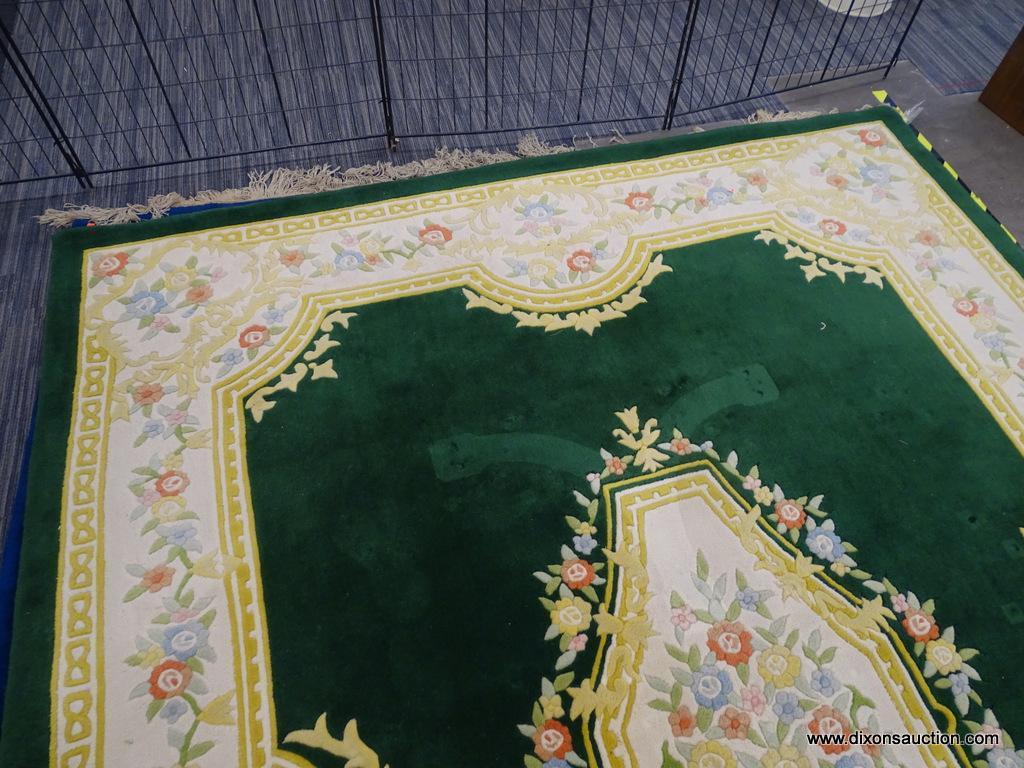 ORIENTAL AREA RUG; GREEN, YELLOW, AND CREAM ORIENTAL AREA RUG WITH YELLOW, BLUE AND RED FLOWERS. HAS