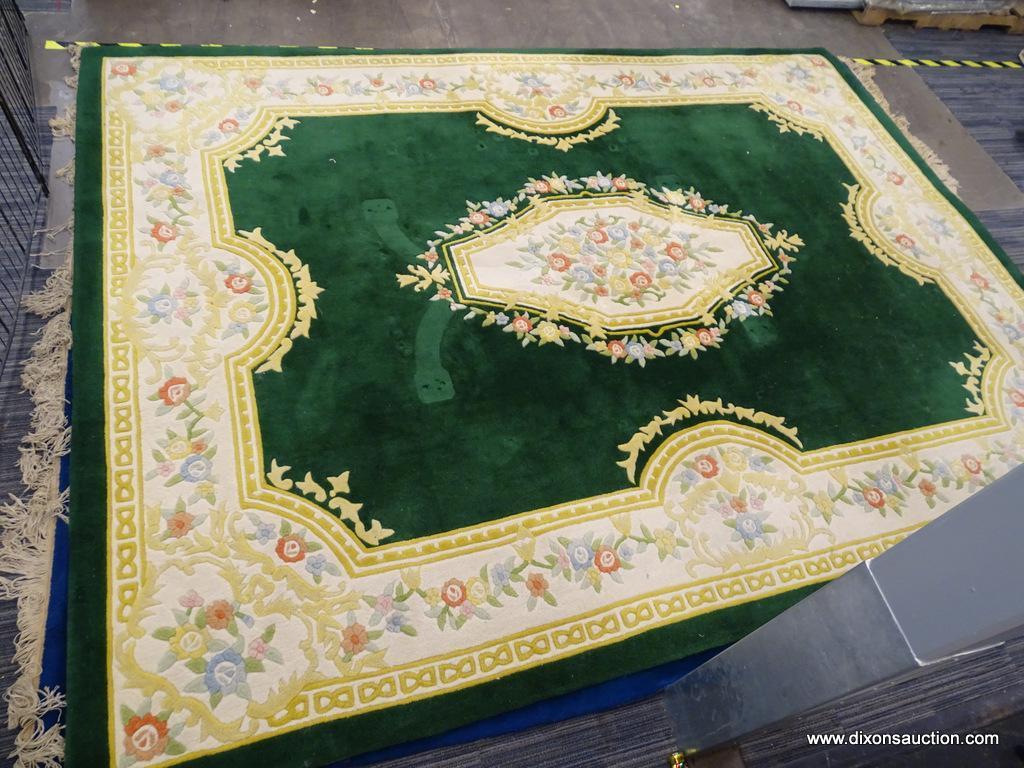 ORIENTAL AREA RUG; GREEN, YELLOW, AND CREAM ORIENTAL AREA RUG WITH YELLOW, BLUE AND RED FLOWERS. HAS