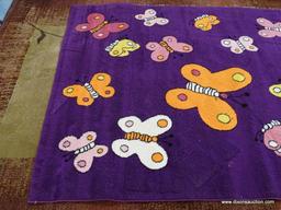 KIDS COLLECTION AREA RUG; HAS A BUTTERFLY PATTER WITH A DARK PURPLE COLOR BASE. BUTTERFLIES AREA