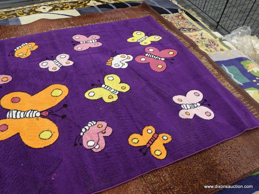 KIDS COLLECTION AREA RUG; HAS A BUTTERFLY PATTER WITH A DARK PURPLE COLOR BASE. BUTTERFLIES AREA