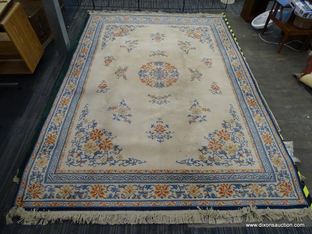 KARASTAN AREA RUG; CHINESE MEDALLION #718 AREA RUG WITH A BEIGE, ORANGE, AND BLUE COLOR. HAS FRINGES