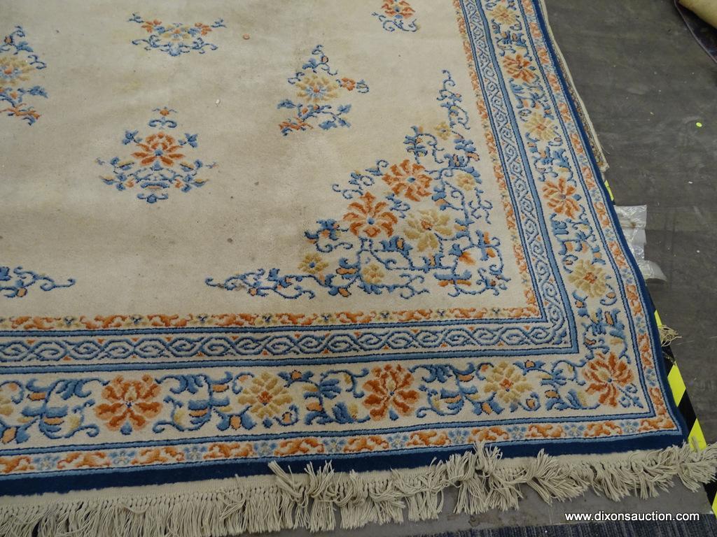 KARASTAN AREA RUG; CHINESE MEDALLION #718 AREA RUG WITH A BEIGE, ORANGE, AND BLUE COLOR. HAS FRINGES