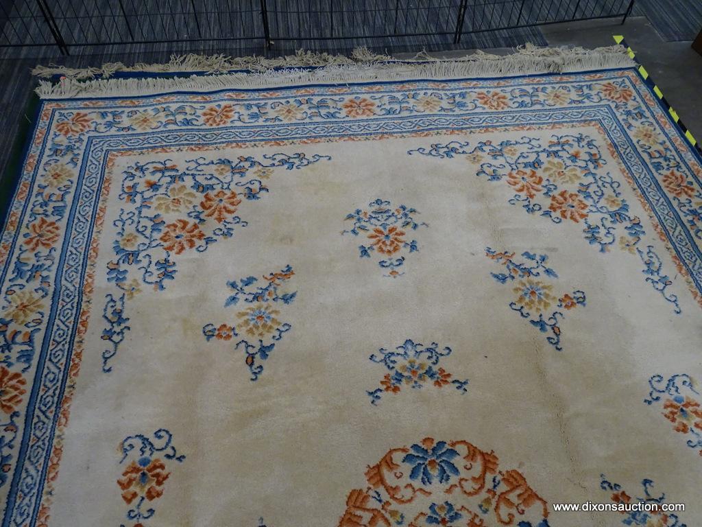 KARASTAN AREA RUG; CHINESE MEDALLION #718 AREA RUG WITH A BEIGE, ORANGE, AND BLUE COLOR. HAS FRINGES