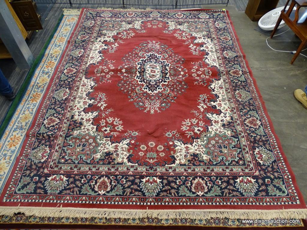 FLORAL AREA RUG; RED, CREAM, NAVY, AND GREEN FLORAL AND LEAF PATTERNED, MACHINE WOVEN AREA RUG WITH