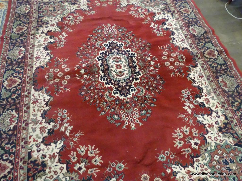 FLORAL AREA RUG; RED, CREAM, NAVY, AND GREEN FLORAL AND LEAF PATTERNED, MACHINE WOVEN AREA RUG WITH
