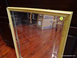 (LIBRARY) GOLD TONE FRAMED WALL MIRROR; BEVELED SECTIONS ALONG THE INSIDE OF THE FRAME. MEASURES