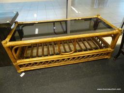 (WINDOW) COFFEE TABLE; GLASS TOP WOODEN COFFEE TABLE WITH RATTAN BOUND JOINTS AND LOWER SHELF