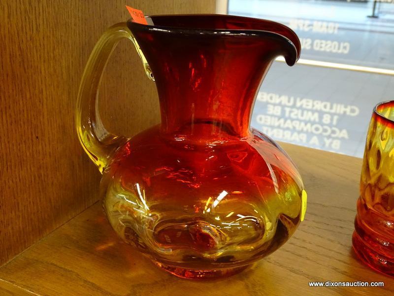 (R1) CUP AND PITCHER; HAND BLOWN CARNIVAL GLASS CUP AND PITCHER WITH RED AND AMBER TINT.