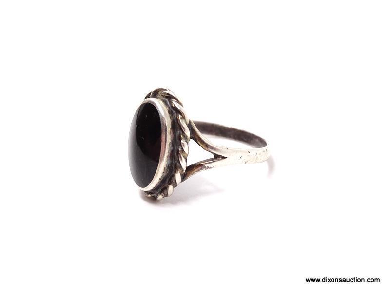 LADIES STERLING SILVER AND ONYX RING; BLACK ONYX OVAL SHAPED CENTER STONE ON A STERLING SILVER BAND.