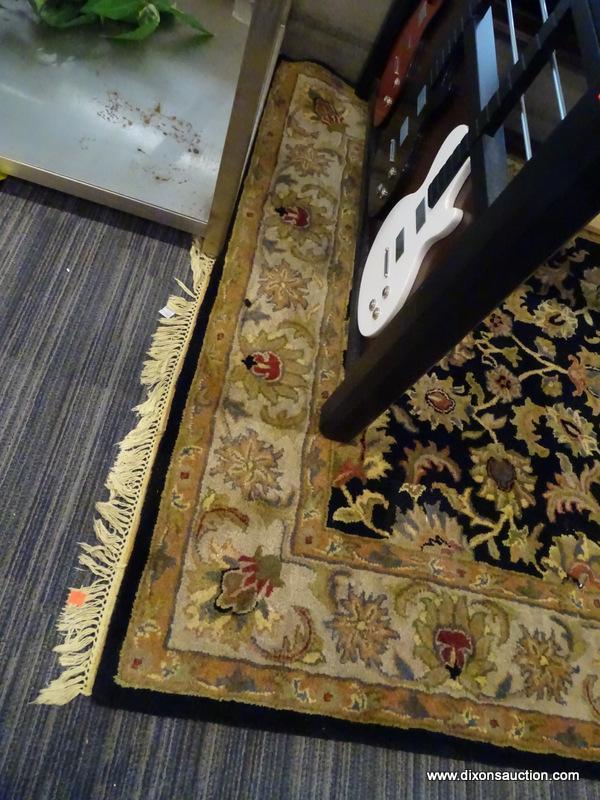 (WINDOW) RUGS USA WOOL PILE RUG; HAND TUFTED, BLACK AND BEIGE RUG WITH A FLORAL PATTERN. HAS FRINGES