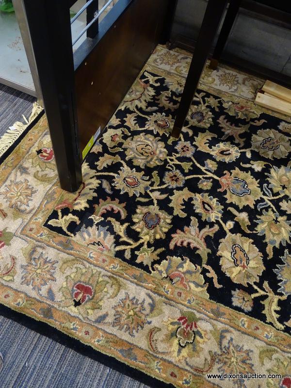 (WINDOW) RUGS USA WOOL PILE RUG; HAND TUFTED, BLACK AND BEIGE RUG WITH A FLORAL PATTERN. HAS FRINGES