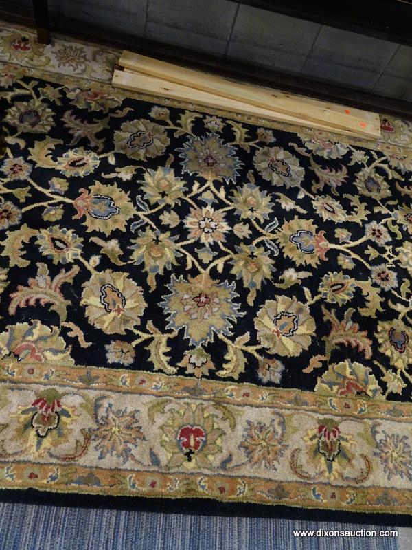 (WINDOW) RUGS USA WOOL PILE RUG; HAND TUFTED, BLACK AND BEIGE RUG WITH A FLORAL PATTERN. HAS FRINGES
