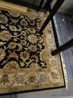 (WINDOW) RUGS USA WOOL PILE RUG; HAND TUFTED, BLACK AND BEIGE RUG WITH A FLORAL PATTERN. HAS FRINGES