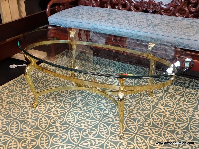 (R1) OVAL COFFEE TABLE; GLASS TOP, OVAL COFFEE TABLE WITH A POLISHED BRASS BASE. MEASURES 49" X