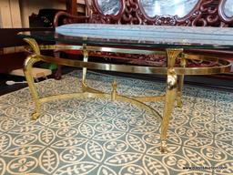 (R1) OVAL COFFEE TABLE; GLASS TOP, OVAL COFFEE TABLE WITH A POLISHED BRASS BASE. MEASURES 49" X