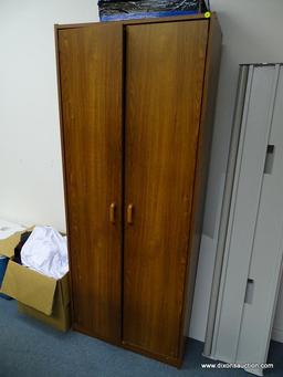 (OFC3) WOOD GRAIN 2 DOOR STORAGE CABINET. HAS MULTIPLE STORAGE SLOTS. MEASURES 29" X 15" X 71" TALL.