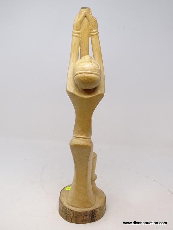 (RFRT) HAND CARVED WOODEN, AFRICAN FIGURINE OF A MAN HOLDING A POLE HIGH IN THE AIR ABOVE A BOWL,