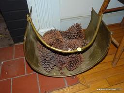 (LR) HAMMERED BRASS FIRELOG HOLDER (INCLUDES PINECONES); SITS ON 4 LEGS AND HAS A SWINGING ARCH