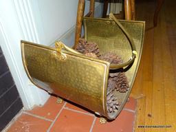 (LR) HAMMERED BRASS FIRELOG HOLDER (INCLUDES PINECONES); SITS ON 4 LEGS AND HAS A SWINGING ARCH