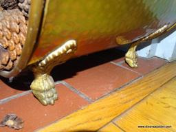 (LR) HAMMERED BRASS FIRELOG HOLDER (INCLUDES PINECONES); SITS ON 4 LEGS AND HAS A SWINGING ARCH